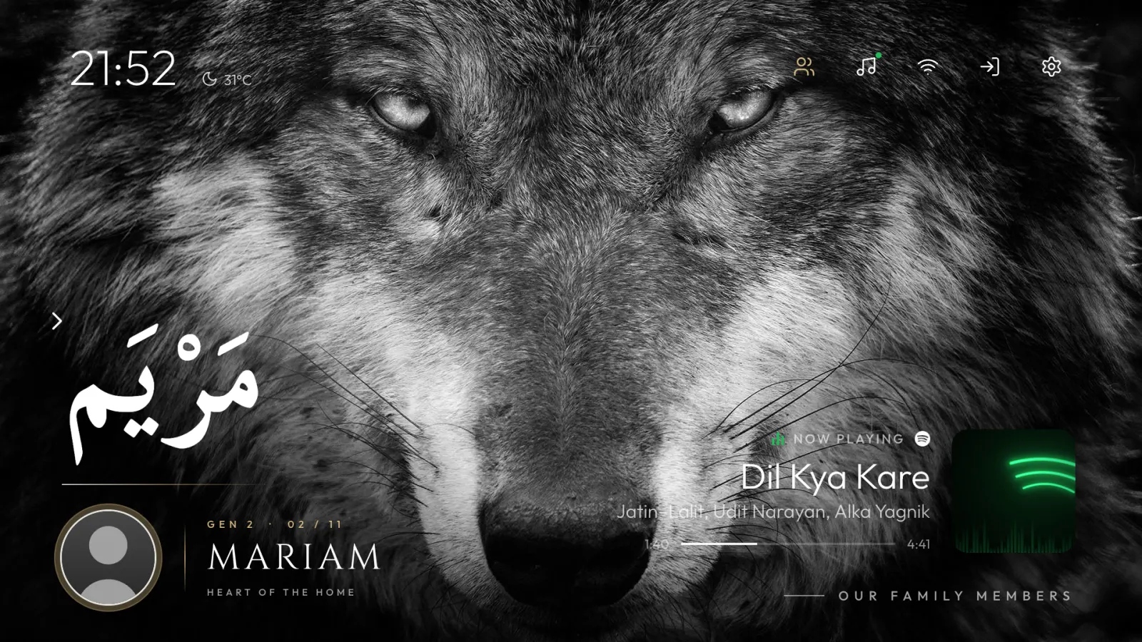 The custom home: a wolf wallpaper, the clock, a family greeting and what's playing.